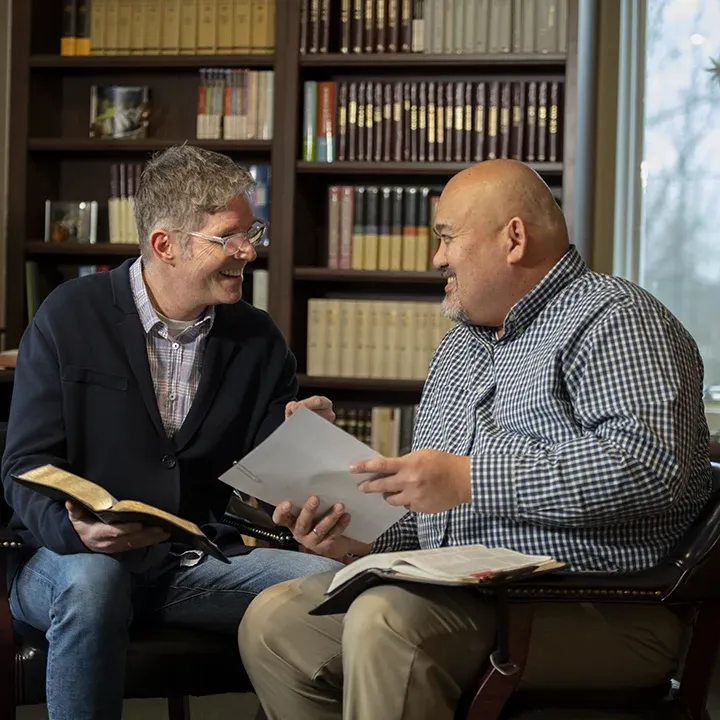 Two pastors reading Bible and talking